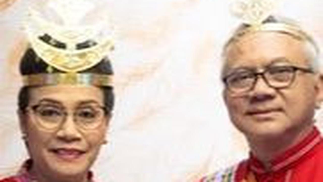 Sri Mulyani dan Tonny Sumartono serasi dalam balutan busana senada merah. Meski warna dasar baju berbeda, kain yang terpasang di pundak memiliki motif yang serupa.