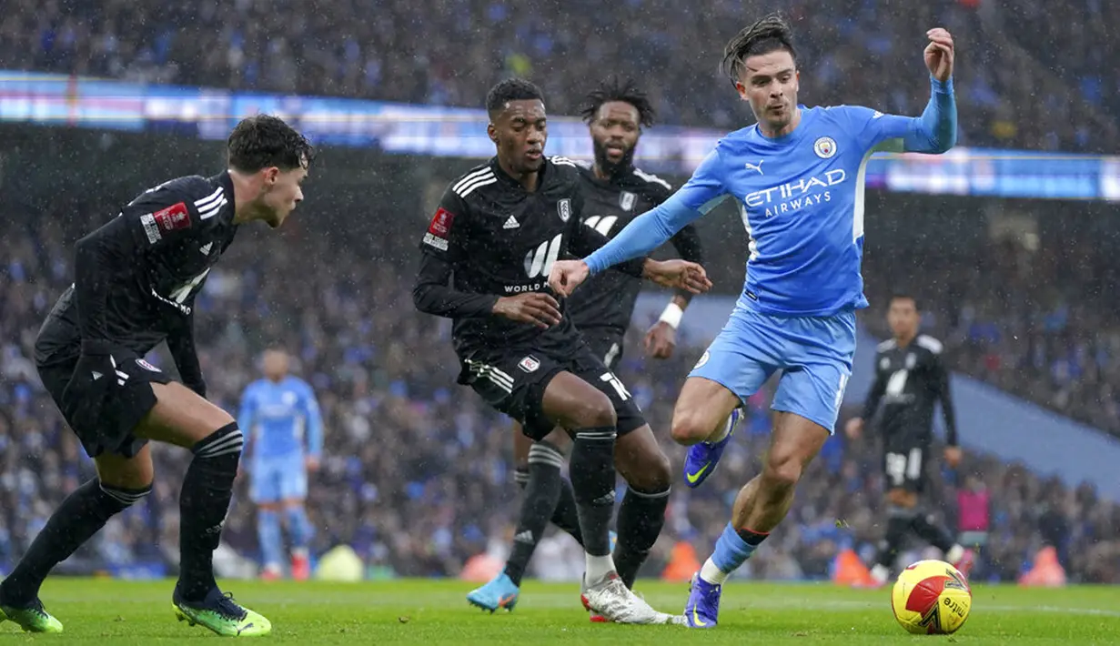 Pemain Manchester City Jack Grealish (kanan) menggiring bola saat melawan Fulham pada pertandingan sepak bola putaran keempat Piala FA di Etihad Stadium, Manchester, Inggris, 5 Februari 2022. Manchester City menang 4-1. (AP Photo/Jon Super)