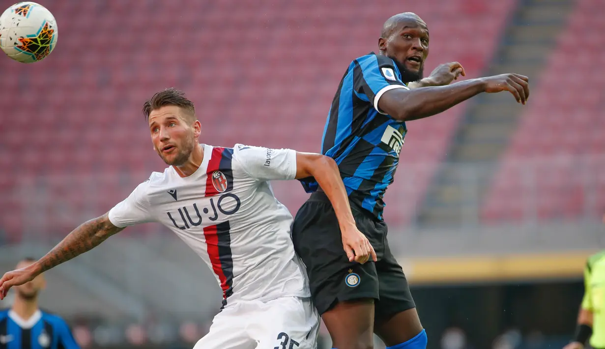 Pemain Bologna, Mitchell Dijks dan penyerang Inter Milan, Lautaro Martinez melompat saat berebut bola pada pekan ke-30 Serie A 2019-2020, di Stadion Giuseppe Meazza, Minggu (5/7/2020). Inter Milan ditumbangkan Bologna 1-2 di kandang sendiri. (AP /Antonio Calanni)