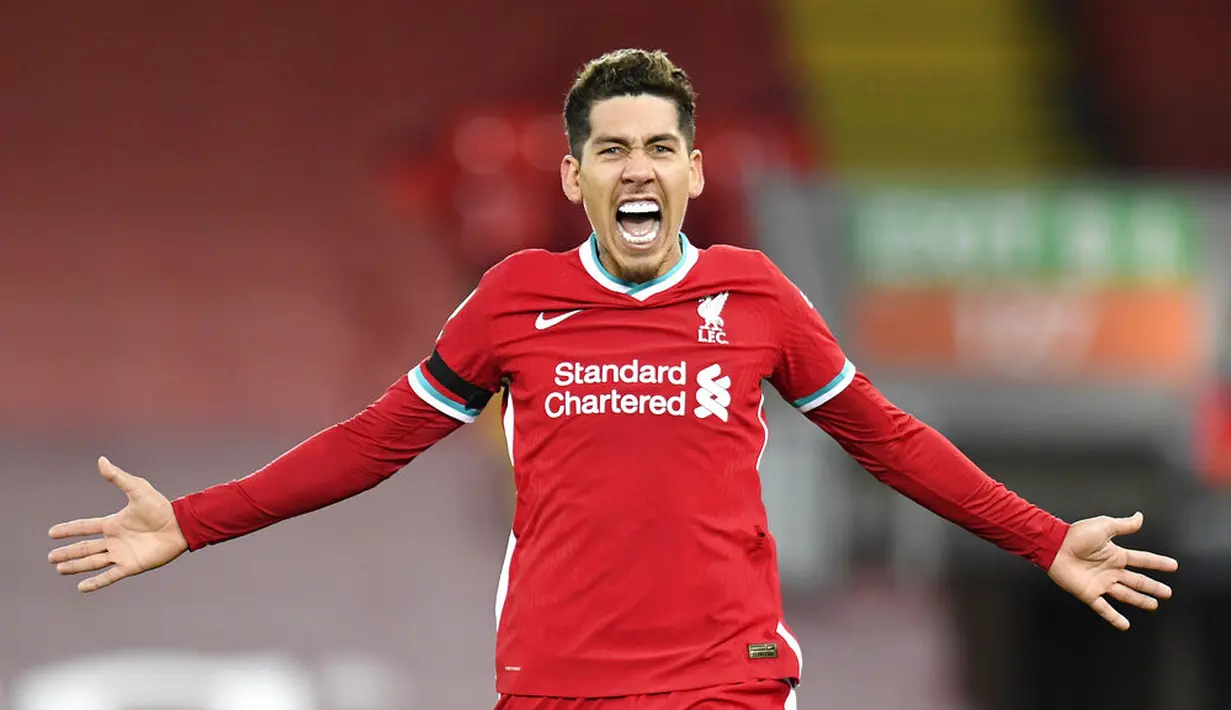 Pemain Liverpool Roberto Firmino merayakan setelah mencetak gol gawang Tottenham Hotspur pada pertandingan Liga Inggris di Anfield, Liverpool, Inggris, Rabu (16/12/2020). Liverpool mengudeta Tottenham dari puncak klasemen usai menang 2-1. (Peter Powell/ Pool via AP)