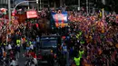 Para pemain Barcelona berada di atas bus saat melakukan parade u di Barcelona (30/4). Dengan bus atap terbuka, Lionel Messi dan kawan-kawan memamerkan Piala Liga Spayol dan juga Piala Copa del Rey. (AP/Manu Fernandez)