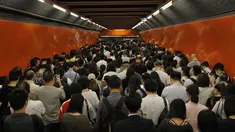 Penumpang mengantri di platform kereta bawah tanah di Hong Kong (30/7/2019). Para pengunjuk rasa telah mengganggu layanan kereta bawah tanah pada pagi hari perjalanan dengan menghalangi pintu-pintu masuk kereta dan mencegah mereka meninggalkan stasiun. (AP Photo/Vincent Yu)