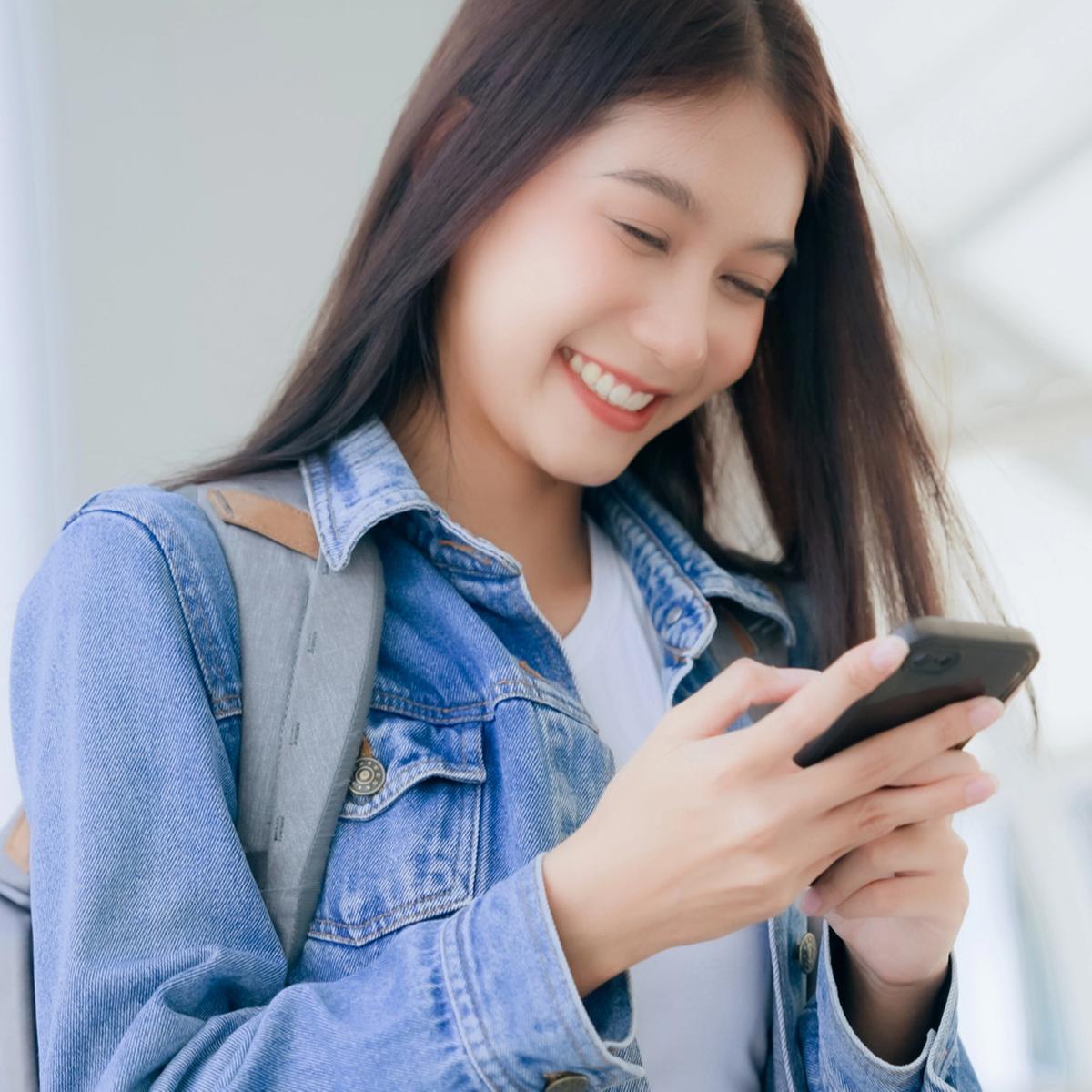 Seorang wanita memakai ponsel