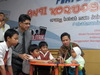 Pimpinan KPK, Laode M Syarif bermain Boardgames Antikorupsi bersama anak-anak SD di KPK, Jakarta, Jumat (15/4). Boardgames Antikorupsi merupakan inovasi terbaru dalam mengkampanyekan pemberantasan korupsi di Indonesia. (Liputan6.com/Helmi Afandi)