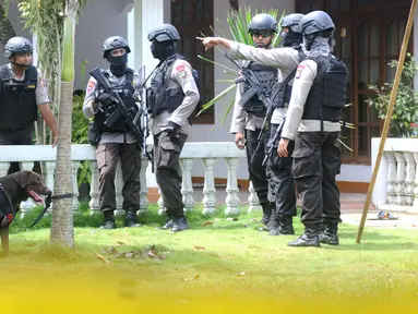 Petugas kepolisian Brimob Polda Metro Jaya mengerahkan anjing pelacak serta menyisir area tempat kejadian perkara (TKP) penggerebekan terduga teroris di setu, Tangerang Selatan, Banten, Rabu (21/12). (Liputan6.com/Helmi Affandi)