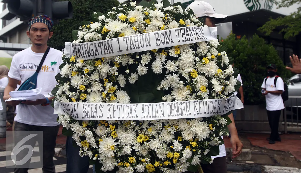 Sejumlah orang melakukan aksi berjalan membawa buga menuju Pos Polisi di MH Thamrin, Sarinah, Jakarta, Sabtu (14/1). Aksi tersebut bentuk dukungan kepada Kepolisian dan instansi terkait dalam pencegahan terorisme. (Liputan6.com/JohanTallo)