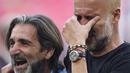 Pelatih Manchester City, Pep Guardiola (kanan), menyeka air matanya setelah berhasil membawa timnya keluar sebagai juara Piala FA 2022/2023 dalam pertandingan final FA Cup melawan Manchester United yang berlangsung di Wembley, Sabtu (3/6/2023) WIB. (AP Photo/Dave Thompson)