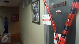 Kertas segel KPK terpasang di pintu ruang kerja anggota DPR dari Fraksi Partai Demokrat, I Putu Sudiartana, di Kompleks Parlemen Senayan, Jakarta, Rabu (29/6). Penyegelan terkait dengan Operasi Tangkap Tangan KPK semalam. (Liputan6.com/Johan Tallo)