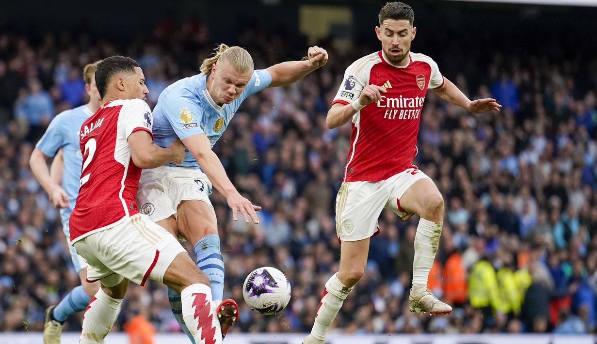 Laga dua tim teratas klasemen sementara Liga Inggris, Arsenal dan Manchester City di Etihad Stadium, Minggu (31/3/2024) tuntas tanpa pemenang. Kedua tim sama-sama gagal mencetak gol hingga laga tuntas 90 menit. Striker andalan tuan rumah, Erling Haaland dibuat tak berkutik oleh barisan belakang The Gunners yang digalang William Saliba dkk. Sama-sama hanya menambah satu poin, Arsenal mengoleksi 65 poin dan Man City 64 poin, keduanya pun kena tikung Liverpool yang menyusup ke puncak klasemen dengan 67 poin berkat kemenangan 2-1 atas Brighton and Hove Albion. (AP Photo/Dave Thompson)