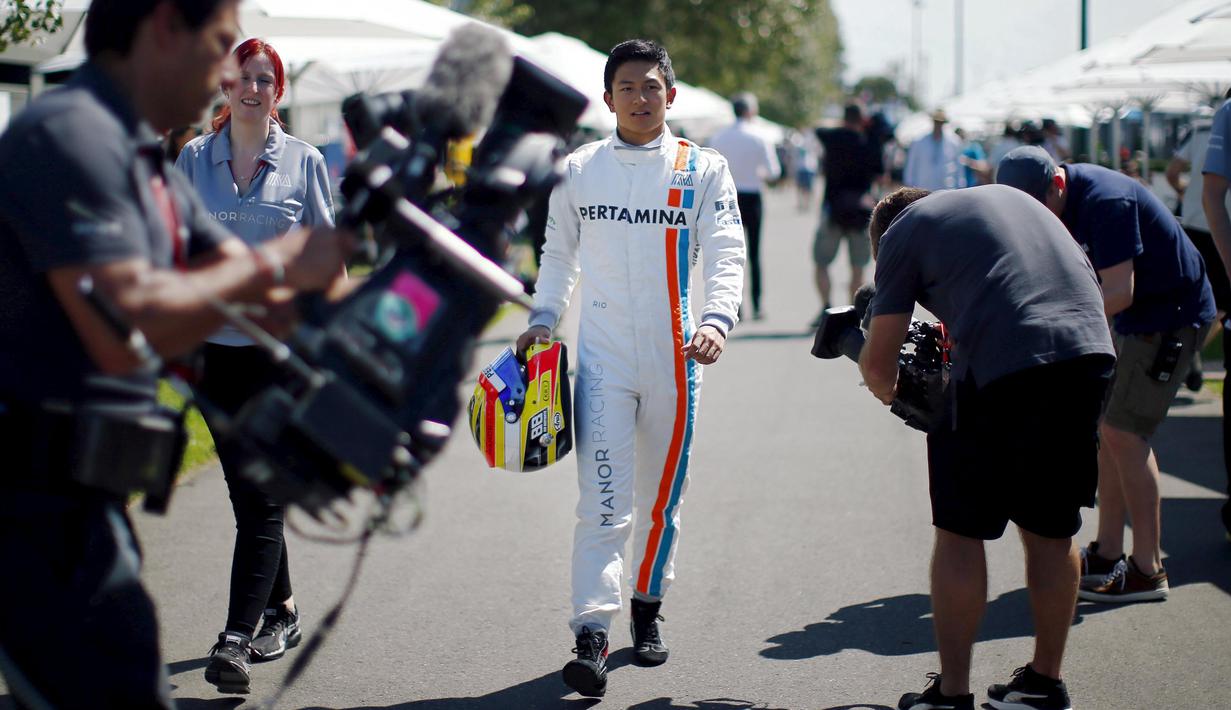 Pebalap Manor Racing F1, Rio Haryanto berjalan melintasi awak media sebelum melakukan sesi foto di Sirkuit Albert Park, Australian Formula One Grand Prix, Melbourne.Kamis (17/3/2016). (REUTERS/Jason Reed)