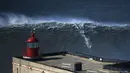 Seorang peselancar bermain diatas ombak yang besar di Praia do Norte, Nazare, Portugal, (19/2/16). Praiado Norte adalah salah satu surga bagi para peselancar dunia. (REUTERS/Rafael Marchante)