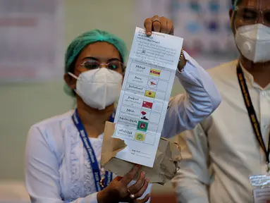 Seorang petugas Komisi Pemilihan Umum memperlihatkan surat suara dalam proses penghitungan pemilu multipartai di sebuah tempat pemungutan suara di Yangon, 8 November 2020. Myanmar sukses menyelesaikan pemungutan suara pemilu multipartai di seluruh negara tersebut pada Minggu (8/11). (Xinhua/U Aung)