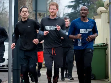 Pangeran Harry berlari dengan relawan dan para tunawisma dari The Running Charity di Willesden Green, Inggris (26/1). Acara amal ini untuk membantu para tunawisma muda mengembangkan keterampilan hidup melalui olahraga. (Geoff Pugh, Foto Renang via AP)