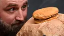 Casey Dean memeriksa burger McDonald's yang dibeli pada 1995 dan disimpan di gudang Australia selama bertahun-tahun, di Melbourne, 7 November 2019. Meski burger sedikit menyusut dari ukuran asli, bentuknya tetap utuh dan tidak ada tanda-tanda jamur serta berbau. (William WEST/AFP)