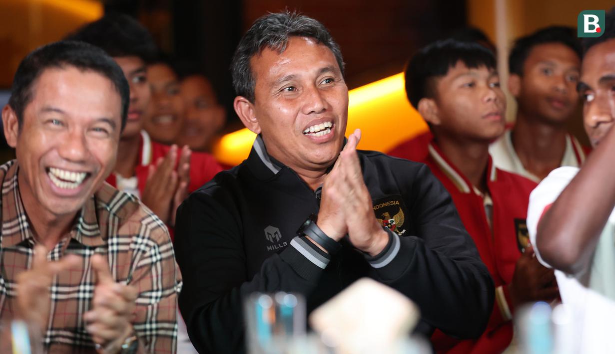 Ekspresi pelatih Timnas Indonesi U-17, Bima Sakti (tengah), dan Sekjen PSSI, Yunus Nusi (kiri) setelah acara pengundian babak penyisihan grup Piala Dunia U-17 2023 dari salah satu restoran di Jakarta, Jumat (16/9/2023). (Bola.com/Abdul Aziz)