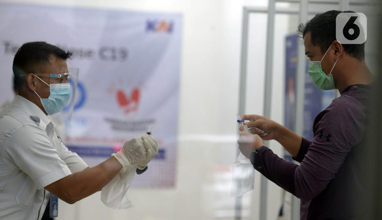 Petugas mengajari calon penumpang untuk tes COVID-19 dengan GeNose C19 di Stasiun Pasar Senen, Jakarta, Selasa (23/2/2021). PT KAI memberikan pelayanan tes COVID-19 dengan GeNose C19 bagi calon penumpang kereta jarak jauh untuk memutus rantai penyebaran virus corona. (merdeka.com/Imam Buhori)