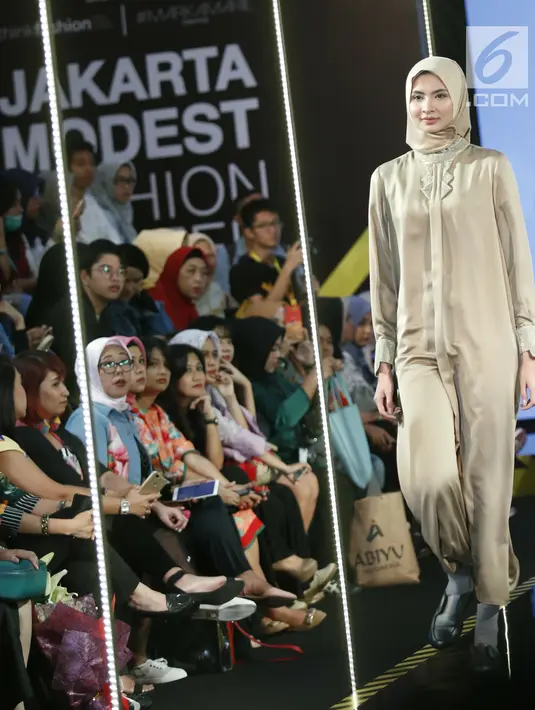 Model berjalan di atas catwalk mengenakan busana L.tru X Fenita Arie dalam ajang Jakarta Modest  Fashion Week, di Gandaria City, Jakarta, Jumat, (27/7). (Kapanlagi.com/Agus Apriyanto)