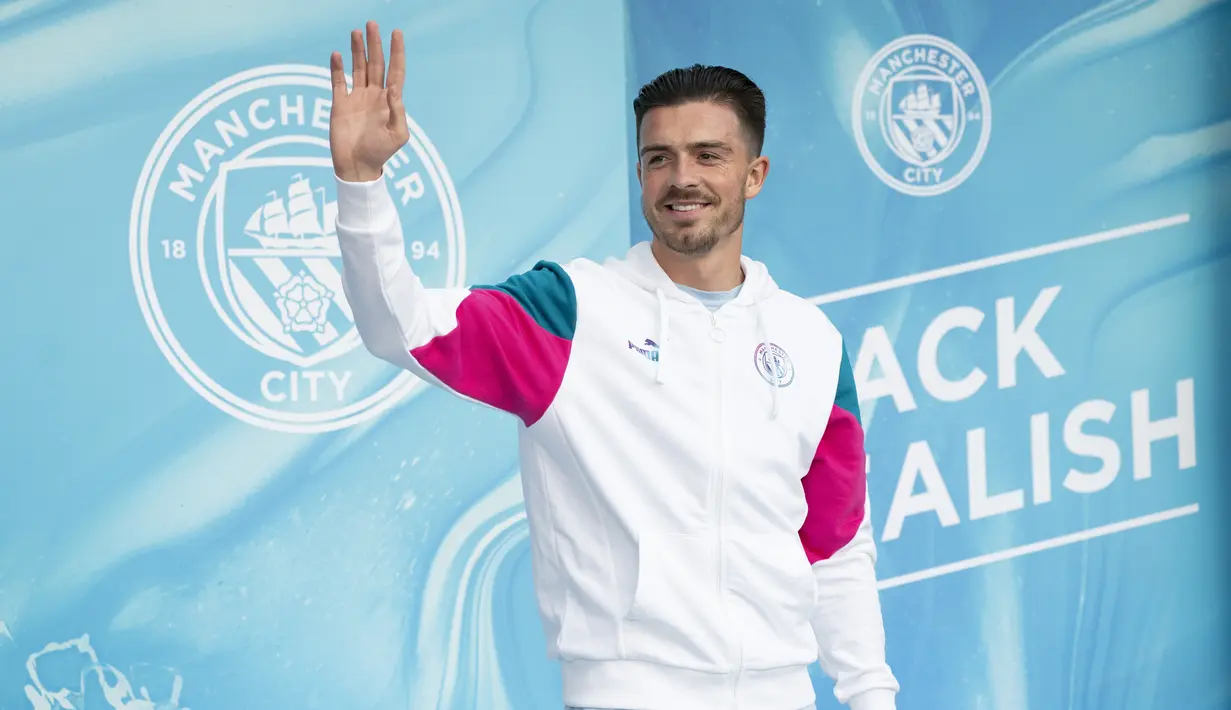 Pemain baru Manchester City, Jack Grealish melambaikan tangan ke penggemar saat diperkenalkan di Stadion Etihad, Senin (9/8/2021). Jack Grealish meneken kontrak enam tahun bersama The Citizens setelah menolak tawaran perpanjangan masa pengabdian di Villa. (AP Photo/Jon Super)