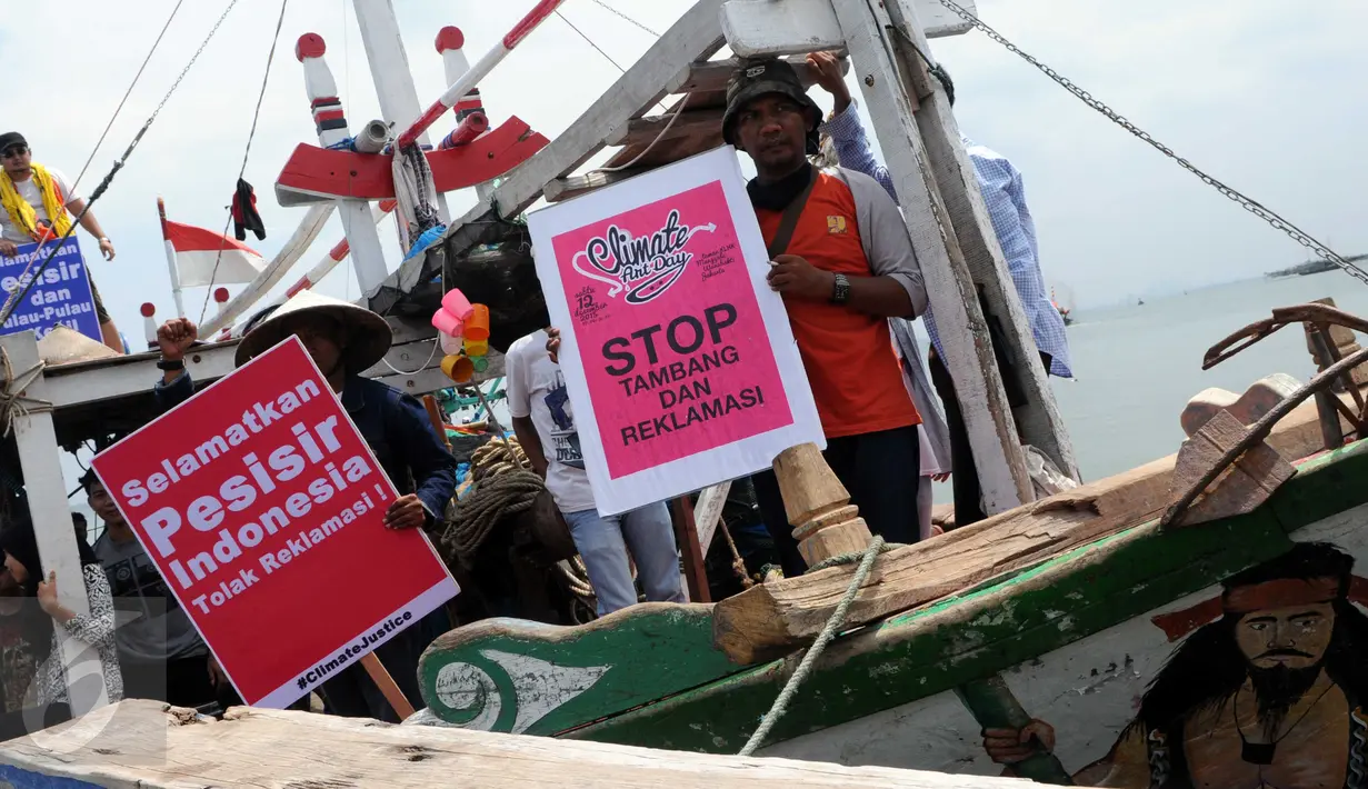Sejumlah nelayan bersama aktivis Walhi menunjukkan poster berisi penolakan terhadap proyek reklamasi Teluk Jakarta saat upacara sedekah bumi yang lebih dikenal dengan sebutan Nadran di Muara Angke, Jakarta, Minggu (13/12/2015). (Liputan6.com/Helmi Afandi)