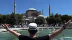 Seorang pemuda memberi isyarat saat menunggu di luar Hagia Sophia, Istanbul, Turki, Jumat (24/7/2020). Umat muslim melaksanakan salat Jumat pertama di Hagia Sophia dalam 86 tahun terakhir. (AP Photo/Yasin Akgul)
