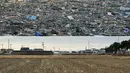 Foto menunjukkan puing-puing akibat bencana tsunami di Natori, Prefektur Miyagi, Jepang, pada 13 Maret 2011 (atas) dan kondisi area yang sama 10 tahun kemudian, pada 26 Januari 2021 (bawah). (AFP/Kazuhiro Nogi, Mike Clarke)