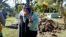 Seorang wanita menangis menyaksikan pemindahkan jasad dari kuburan di Desa Toto Selatan, Kabupaten Bone Bolango, Gorontalo, Sabtu (12/1). Pemindahan kuburan berlangsung aman dan lancar. (Liputan6.com/Arfandi Ibrahim)