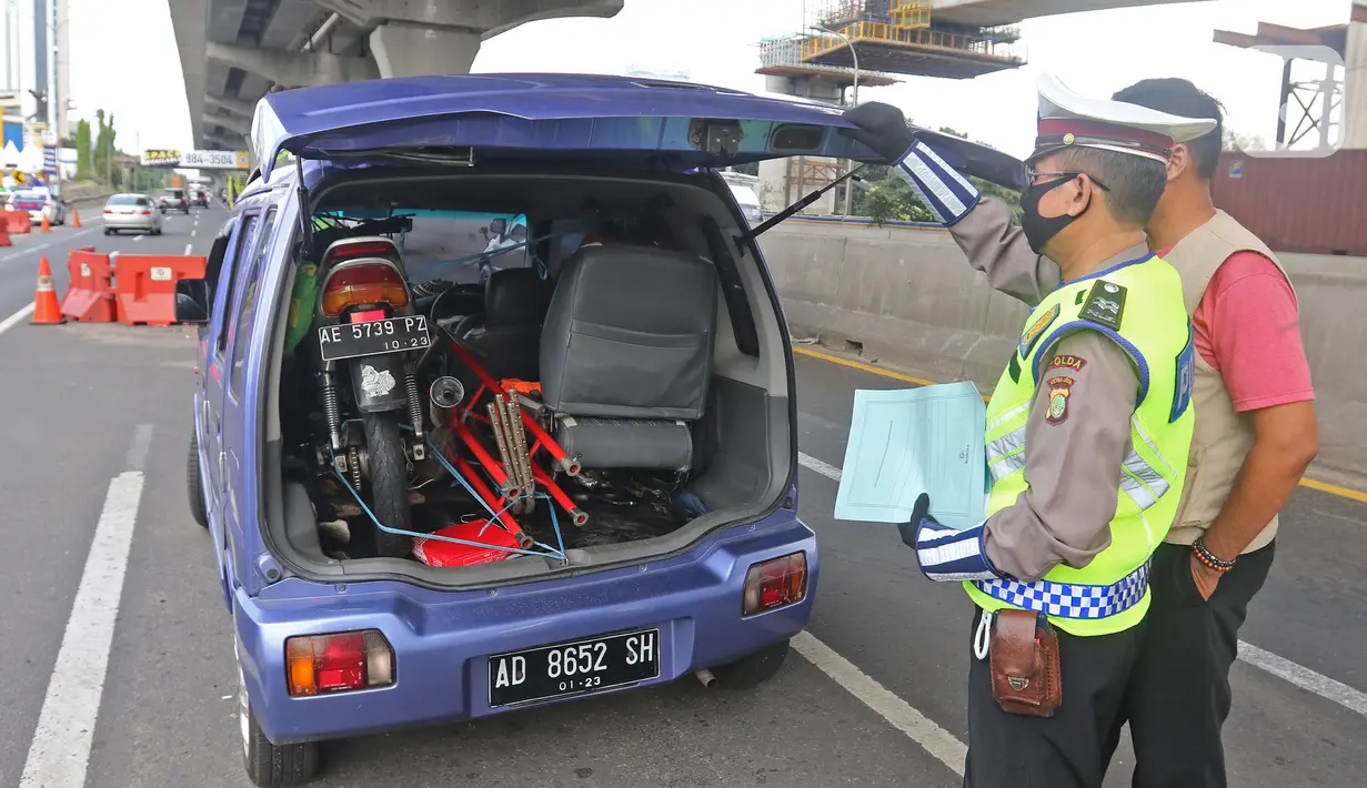 Polisi memeriksa kendaraan di Pos Penyekatan Jalur Mudik, Gerbang Tol Cikarang Barat, Bekasi, Rabu (20/5/2020). Sejak 24 April sampai 19 Mei 2020, Ditlantas Polda Metro Jaya telah memutarbalikkan 20.972 kendaraan mudik Lebaran yang hendak meninggalkan Jabodetabek. (Liputan6.com/Herman Zakharia)