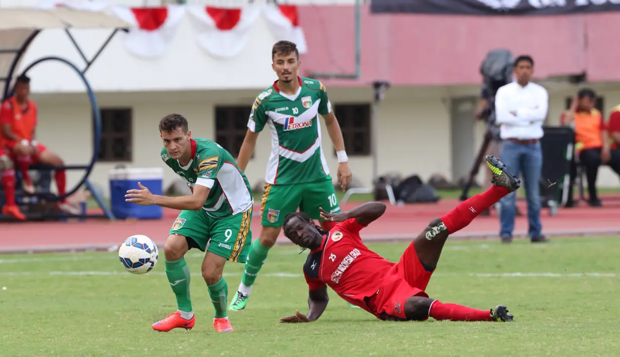 Pemain Mitra Kukar, Patrick do Santos (kiri), berebut bola dengan pemain Semen Padang, Mohamadou Alhadji, pada lanjutan Grup D Piala Jenderal Sudirman 2015 di Stadion Manahan, Solo, Selasa (15/12/2015). (Bola.com/Nicklas Hanoatubun)
