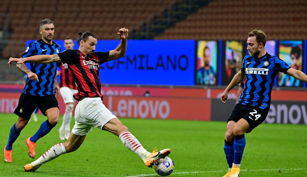 Penyerang AC Milan, Zlatan Ibrahimovic, berebut bola atas dengan gelandang Inter Milan, Christian Eriksen, pada laga lanjutan Liga Italia di Stadion San Siro, Sabtu (17/10/2020) malam WIB. AC Milan menang 2-1 atas Inter Milan. (AFP/Miguel Medina)