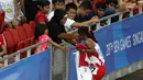 Triyaningsih mencium tangan sang bunda setelah meraih emas nomor lari 5.000m SEA Games yang berlangsung di Stadion Nasional Singapura. Selasa (9/6). (Bola.com/Arief Bagus)