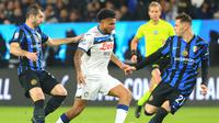 Gelandang Atalanta asal Brasil, Ederson, dijaga oleh gelandang Inter Milan asal Armenia, Henrikh Mkhitaryan, dan gelandang Inter Milan asal Albania, Kristjan Asllani selama pertandingan sepak bola semifinal Piala Super Italia antara Inter Milan dan Atalanta di Taman Al-Awwal di Riyadh pada 2 Januari 2025.Fayez NURELDINE / AFP