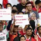 Pendukung timnas Indonesia membentang kertas tulisan saat menyaksikan laga kualifikasi Grup A Piala AFF 2022 antara Indonesia melawan Kamboja di di Stadion Utama Gelora Bung Karno, Jakarta, Jumat (23/12/2022). Indonesia unggul 2-1 atas Kamboja lewat gol yang dicetak Egy Maulana Vikry dan Witan Sulaeman. (Liputan6.com/Helmi Fithriansyah)