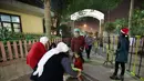 Muslim Kuwait membagikan permen selama misa Natal di Gereja Evangelis Nasional di Kota Kuwait (24/12). (AP Photo/Yasser Al-Zayyat)