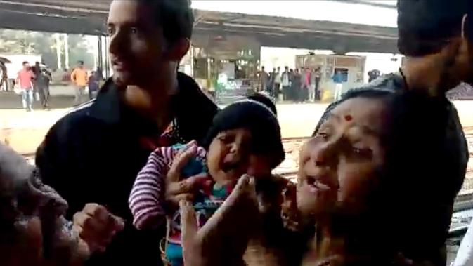 Gambar dari video pada 20 November 2018, bayi India berada dalam gendongan setelah terjatuh tepat di samping rel di stasiun kereta api di Mathura, Uttar Pradesh. Bayi itu terlepas dari gendongan dan jatuh saat ibunya turun dari kereta api (NNIS / AFP)