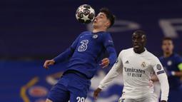 Gelandang Chelsea, Kai Havertz (kiri) mengontrol bola di depan bek Real madrid, Ferland Mendy dalam laga leg kedua semifinal Liga Champions 2020/2021 di Stamford Bridge, London, Rabu (5/5/2021). Chelsea menang 2-0 atas Real Madrid. (AP/Alastair Grant)