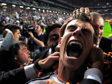 Pemain Real Madrid Gareth Bale melakukan selebrasi usai mencetak gol ke gawang Atletico Madrid pada pertandingan sepak bola final Liga Champions di Stadion Luz, Lisbon, Portugal, 24 Mei 2014. Gareth Bale telah mengumumkan pengunduran dirinya dari klub dan sepak bola internasional pada 9 Januari 2023 di usia 33 tahun. (AP Photo/Manu Fernandez, File)