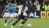 Penyerang Udinese, Keinan Davis berebut bola dengan bek Napoli Giovanni Di Lorenzo pada laga pekan ke-35 Serie A di Bluenergy Stadium, Selasa (7/05/2024) dini hari WIB. (Andrea Bressanutti/Lapresse via AP)