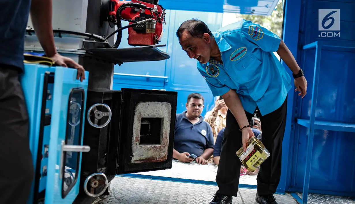 Kepala BNN, Komjen Heru Winarko memasukkan barang bukti narkoba ke dalam mesin pembakar untuk dimusnahkan di Gedung BNN, Jakarta, Jumat (1/3). BNN memusnahkan sebanyak 99,7 Kg sabu, 9.990 butir ekstasi dan 118,34 kg daun khat. (Liputan6.com/Faizal Fanani)