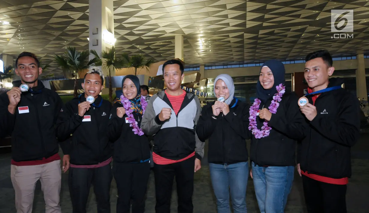 Menpora, Imam Nahrawi (tengah) berfoto bersama Timnas sport climbing Indonesia di Bandara Soetta, Tangerang, Rabu (16/5). Timnas sport climbing Indonesia sukses mempertahankan dominasi di kejuaraan panjat tebing dunia. (Liputan6.com/Helmi Fithriansyah)