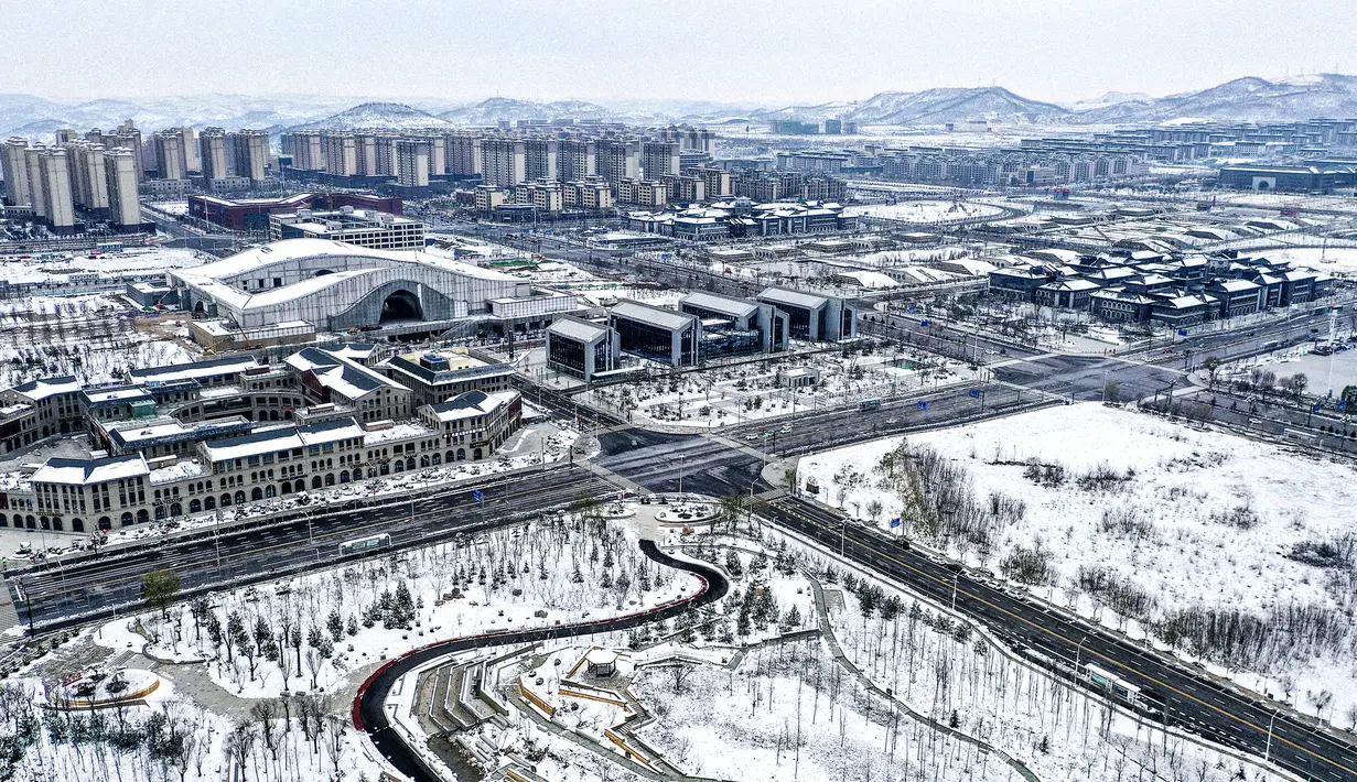 Foto dari udara yang diabadikan pada 23 November 2020 ini menunjukkan pemandangan Kota Yan'an yang diselimuti salju di Provinsi Shaanxi, China barat laut. (Xinhua/Tao Ming)