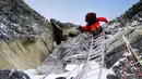 Seorang anggota tim survei China menuju puncak Gunung Qomolangma (27/5/2020). Tim survei China beranggotakan delapan orang berangkat menuju puncak Gunung Qomolangma, puncak tertinggi di dunia, dari kamp gunung di ketinggian 8.300 meter pada (27/5) pukul 02.10 waktu setempat. (Xinhua/Tashi Tsering)