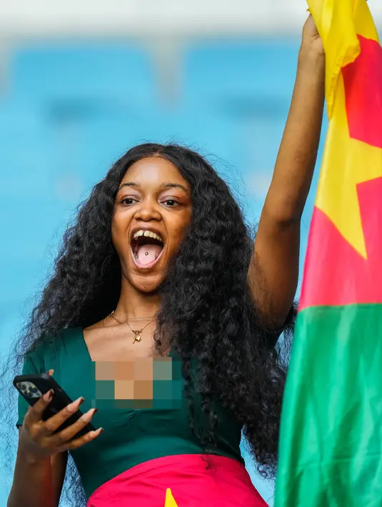 Seorang suporter mengibarkan bendera Kamerun saat pertandingan sepak bola Grup G Piala Dunia 2022 antara Swiss dan Kamerun di Stadion Al Janoub, Al Wakrah, Qatar, Kamis (24/11/2022). (AP Photo/Petr Josek)