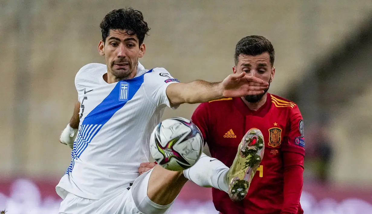 Gelandang timnas Yunani Andreas Bouchalakis berebut bola dengan bek Spanyol, Jose Luis Gaya pada laga Kualifikasi Piala Dunia 2022 zona Eropa Grup B di Olympic stadium, Jumat (12/11/2021) dini hari WIB. Spanyol menaklukkan tuan rumah Yunani dengan skor 1-0. (AP Photo/Thanassis Stavrakis)