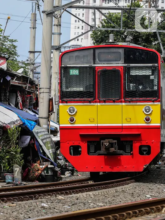 Kereta melintas di bantaran rel kawasan pemukiman padat Pejompongan, Jakarta, Kamis (28/1/2020). Dalam  jangka  waktu  sepuluh  tahun  sejak  tahun  2010,  jumlah  penduduk DKI   meningkat  954  ribu  jiwa,  atau  rata-rata  sebanyak  88  ribu  jiwa  setiap tahun. (Liputan6.com/JohanTallo)