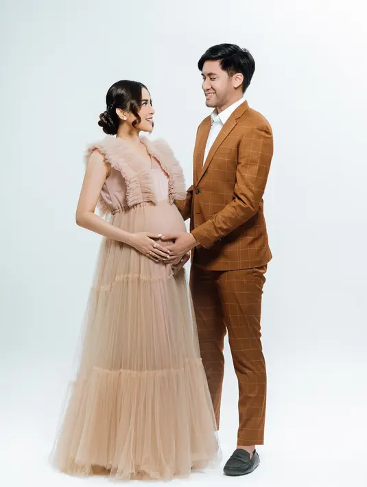 Segera dikaruniai buah hati pertama, keluarga kecil Kevin Aprilio dan Vicy Melanie pun jadi penuh warna. Berpose saling bertatapan dan memegang perut buncit Vicy, pasangan ini romantis. Penuh kebahagiaan, netizen juga turut merasakan bahagianya Vicy dan Kevin. Anaknya diketahui berjenis kelamin perempuan, netizen tak sabar melihat langsung cucu pertama Addie MS ini. (Liputan6.com/IG/@vicymelanie)