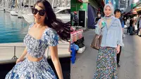 Kemeja dan rok asimetris dengan motif bunga senada ala Pamela Bowie bisa jadi pilihan untuk outfit ke pantai. [Foto: IG/pammybowie].