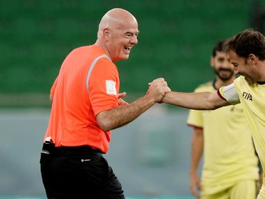 Presiden FIFA, Gianni Infantino, bersalaman dengan Alessandro Del Piero pada laga hiburan jelang semi final Piala Dunia di Stadion Al Thumama, Senin (12/12/2022). (AP Photo/Frank Augstein)