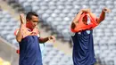 Dua pemain Persela Lamongan mengenakan rompi sebelum latihan di Stadion Utama Gelora Bung Karno, Jakarta, Kamis (12/5/2016). (Bola.com/Nicklas Hanoatubun)