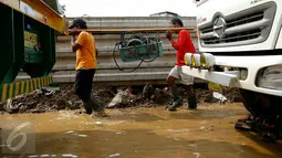 Petugas normalisasi Ciliwung membawa perlengkapan pompa penguras air, Kampung Pulo, Jakarta, Rabu (25/11/2015). Pompa tersebut untuk mempercepat penyurutan banjir di pemukiman Kampung Pulo. (Liputan6.com/Yoppy Renato)