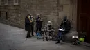 Sekelompok seniman yang mengenakan masker melukis di sebuah jalan di Barcelona, Spanyol, Selasa (9/2/2021). Sejauh ini tercatat 60.000 lebih kematian dengan tembus tiga juta kasus Covid-19 di Spanyol, salah satu negara Eropa yang paling terpukul. (AP Photo/Emilio Morenatti)